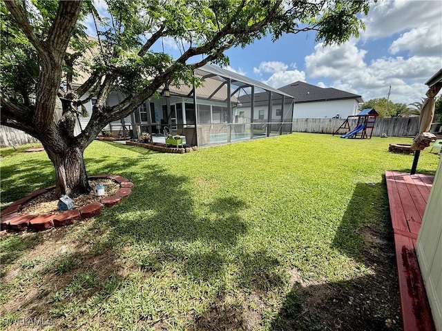view of yard with a fenced backyard, a playground, a fenced in pool, and glass enclosure