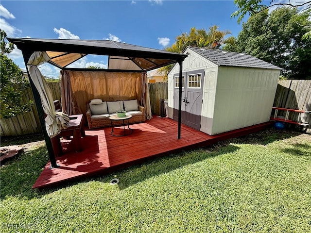 deck with an outdoor structure, a storage shed, a fenced backyard, outdoor lounge area, and a yard