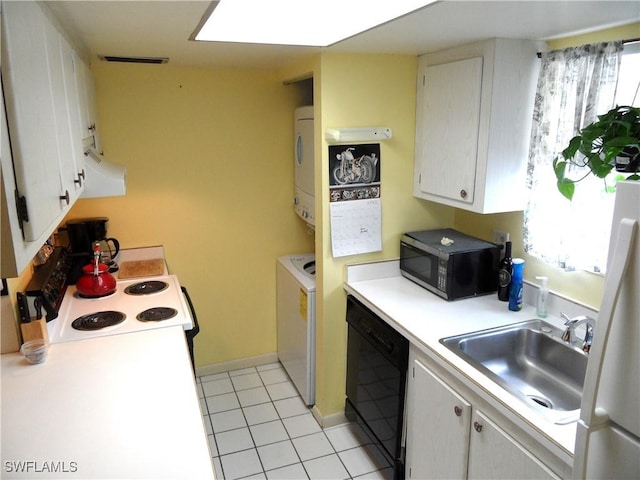 kitchen with light countertops, stacked washer / dryer, a sink, black appliances, and light tile patterned floors