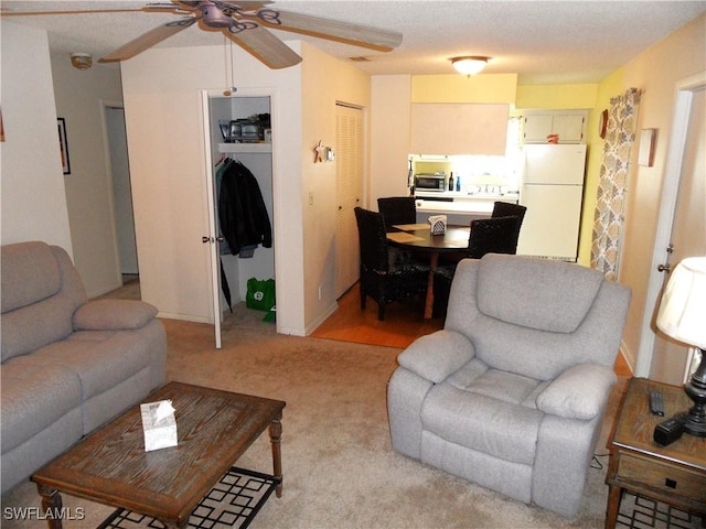 living room featuring a ceiling fan