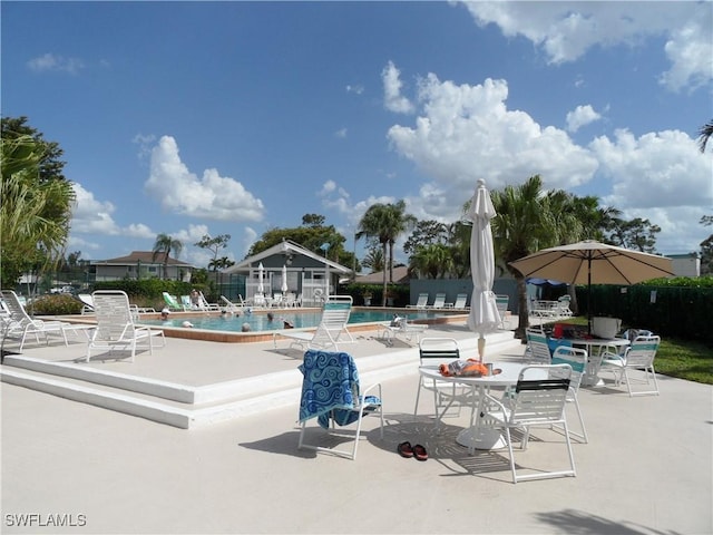 pool featuring fence and a patio