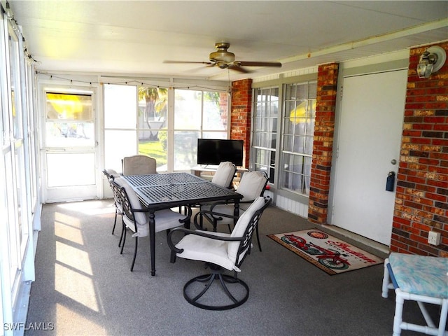 sunroom featuring a ceiling fan and outdoor dining space