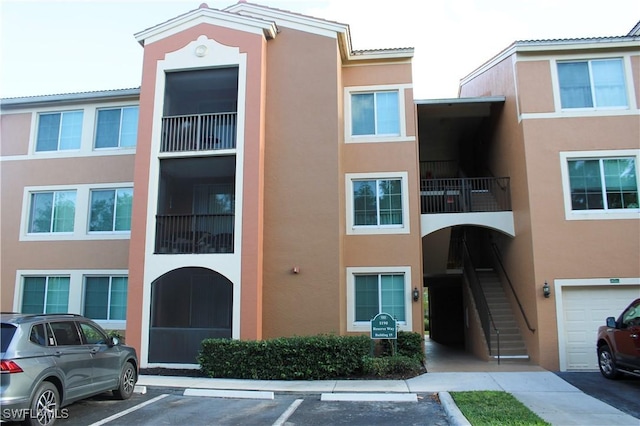 1190 Reserve Way Unit 302, Naples, FL 34105 - view of property featuring stairway and uncovered parking