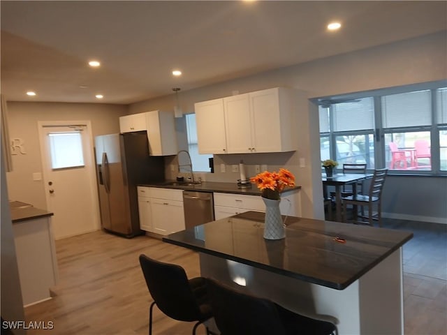 2138 Bahama Ave, Fort Myers, FL 33905 - kitchen with dark countertops, stainless steel appliances, a sink, white cabinets, and recessed lighting