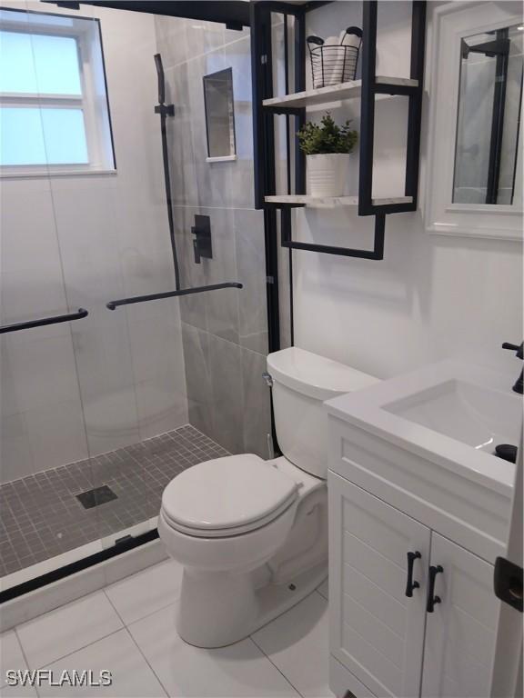 2138 Bahama Ave, Fort Myers, FL 33905 - bathroom featuring toilet, tile patterned floors, a stall shower, and vanity