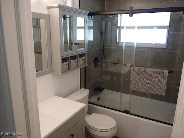 2138 Bahama Ave, Fort Myers, FL 33905 - full bath with healthy amount of natural light, toilet, bath / shower combo with glass door, and vanity