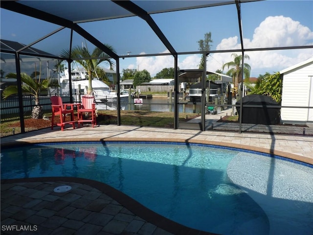 2138 Bahama Ave, Fort Myers, FL 33905 - outdoor pool with glass enclosure, a patio area, a water view, and fence