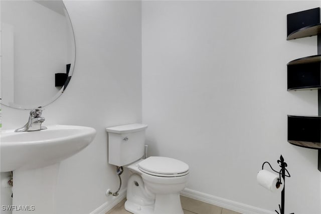 26974 Wildwood Pines Ln, Bonita Springs, FL 34135 - bathroom featuring toilet, baseboards, and tile patterned flooring