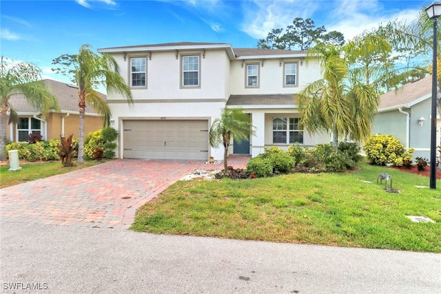26974 Wildwood Pines Ln, Bonita Springs, FL 34135 - traditional-style house with stucco siding, a garage, decorative driveway, and a front lawn