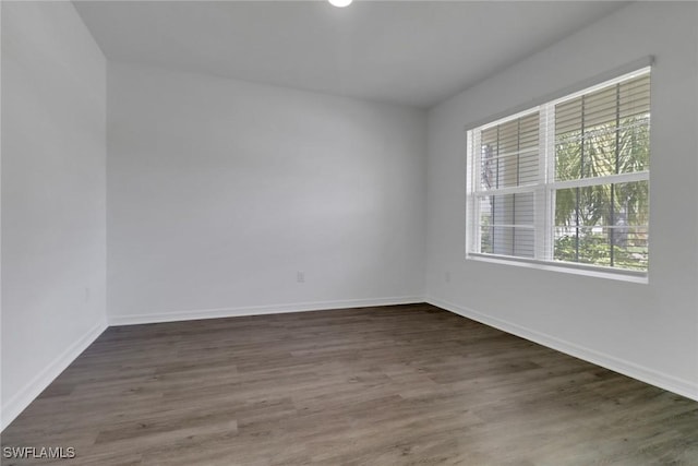26974 Wildwood Pines Ln, Bonita Springs, FL 34135 - empty room featuring wood finished floors and baseboards