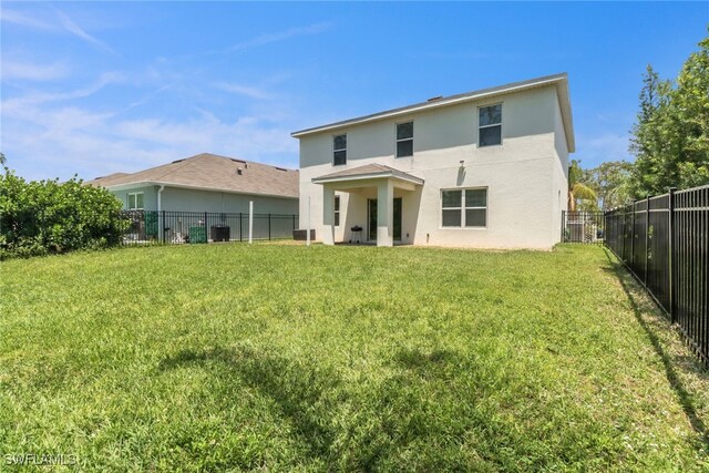 26974 Wildwood Pines Ln, Bonita Springs, FL 34135 - rear view of house featuring stucco siding and central AC unit