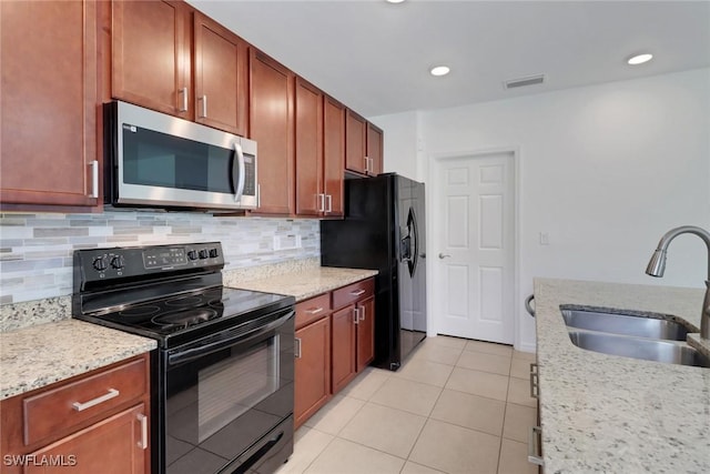 26974 Wildwood Pines Ln, Bonita Springs, FL 34135 - kitchen with black appliances, a sink, decorative backsplash, light tile patterned floors, and recessed lighting