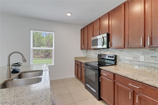 26974 Wildwood Pines Ln, Bonita Springs, FL 34135 - kitchen featuring stainless steel microwave, black range with electric stovetop, a sink, and decorative backsplash