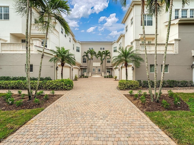 view of community with decorative driveway