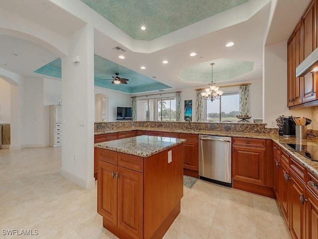 kitchen featuring arched walkways, dishwasher, a peninsula, and a tray ceiling