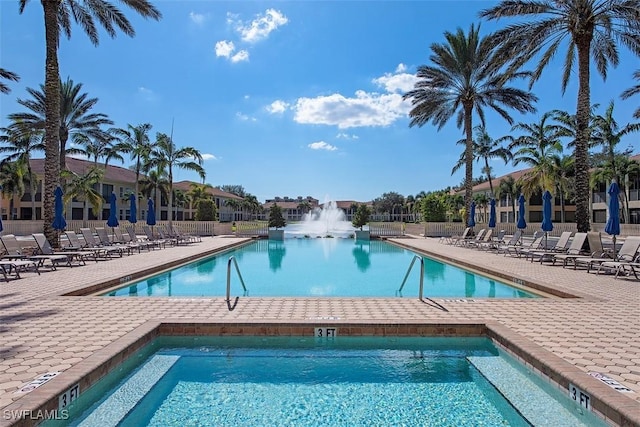community pool with fence and a patio area