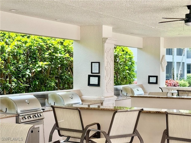 view of patio / terrace featuring a grill, an outdoor kitchen, and ceiling fan