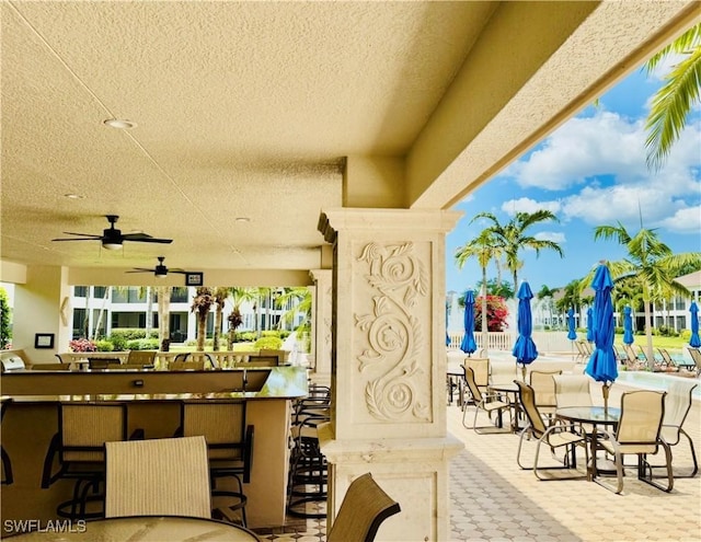 view of patio / terrace with outdoor dry bar and ceiling fan