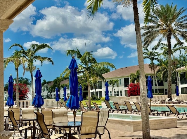584 Avellino Isles Cir Unit 19102, Naples, FL 34119 - view of patio featuring a community pool