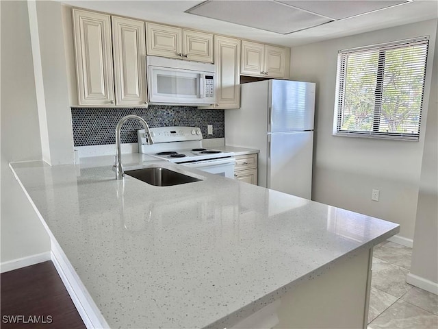 4790 S Cleveland Ave Unit 1605, Fort Myers, FL 33907 - kitchen featuring white appliances, cream cabinets, light stone countertops, and a sink
