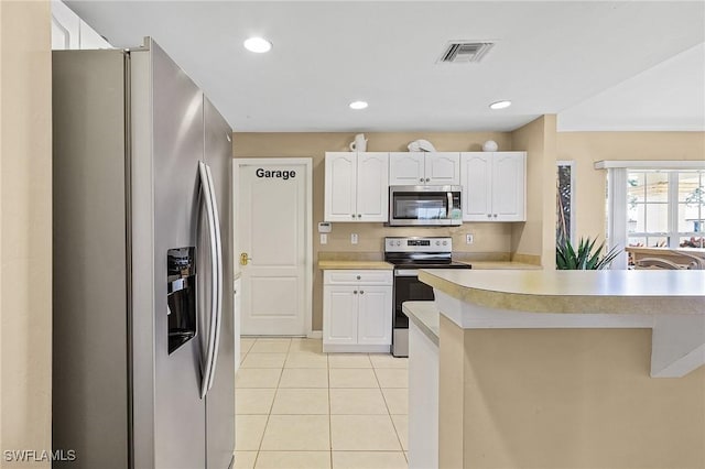924 NE 11th Ave, Cape Coral, FL 33909 - kitchen with white cabinetry, light countertops, stainless steel appliances, light tile patterned flooring, and visible vents