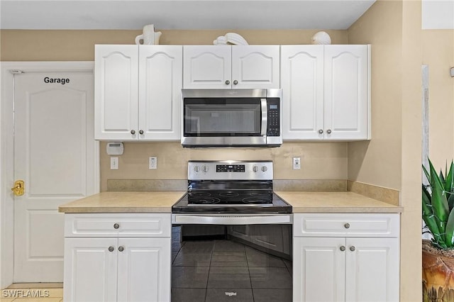 924 NE 11th Ave, Cape Coral, FL 33909 - kitchen with light countertops, stainless steel appliances, and white cabinets