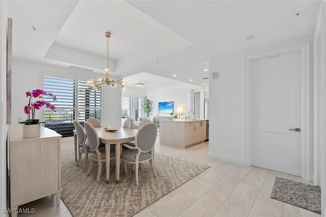 1111 Central Ave Unit 507, Naples, FL 34102 - dining room with a chandelier, a tray ceiling, and recessed lighting