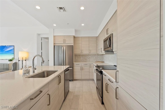 1111 Central Ave Unit 507, Naples, FL 34102 - kitchen featuring stainless steel appliances, a sink, light brown cabinetry, light countertops, and recessed lighting