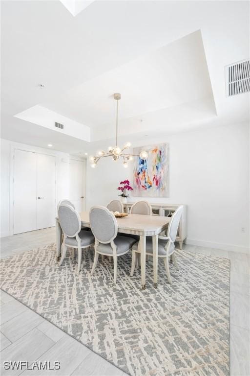 1111 Central Ave Unit 507, Naples, FL 34102 - dining room with a raised ceiling, a chandelier, and baseboards