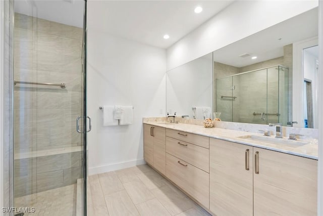 1111 Central Ave Unit 507, Naples, FL 34102 - bathroom with a shower stall, double vanity, recessed lighting, baseboards, and tile patterned flooring