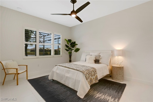 bedroom featuring tile patterned flooring, a ceiling fan, and baseboards