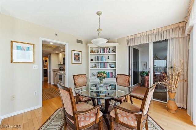 6361 Pelican Bay Blvd Unit 605, Naples, FL 34108 - dining space featuring light wood-style flooring, baseboards, and visible vents