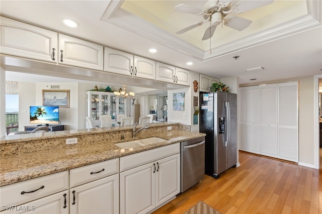 6361 Pelican Bay Blvd Unit 605, Naples, FL 34108 - kitchen with light wood-type flooring, a raised ceiling, light stone countertops, appliances with stainless steel finishes, and a sink