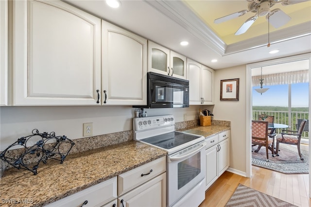 6361 Pelican Bay Blvd Unit 605, Naples, FL 34108 - kitchen with light wood-style floors, black microwave, recessed lighting, electric stove, and a raised ceiling