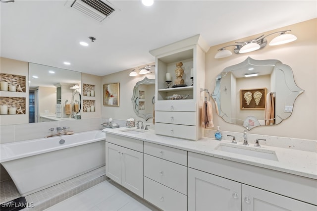 6361 Pelican Bay Blvd Unit 605, Naples, FL 34108 - full bathroom with a freestanding bath, double vanity, visible vents, and a sink