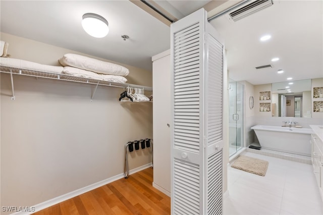 6361 Pelican Bay Blvd Unit 605, Naples, FL 34108 - walk in closet featuring light wood finished floors and visible vents