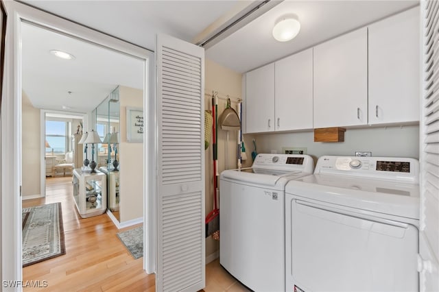 6361 Pelican Bay Blvd Unit 605, Naples, FL 34108 - clothes washing area with independent washer and dryer, light wood finished floors, baseboards, and cabinet space