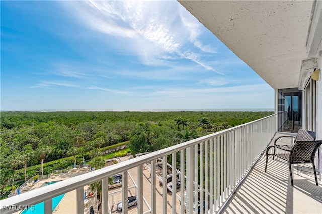6361 Pelican Bay Blvd Unit 605, Naples, FL 34108 - balcony featuring a view of trees