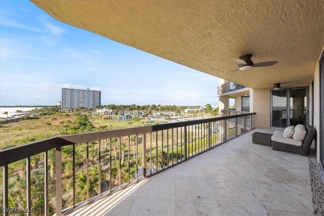174 S Collier Blvd Unit 504, Marco Island, FL 34145 - balcony featuring a ceiling fan and a water view