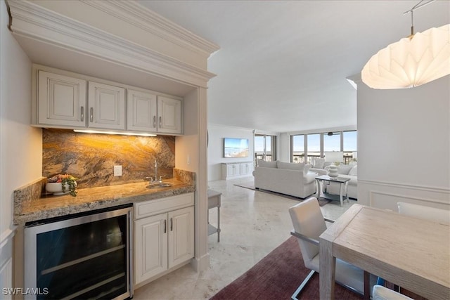 174 S Collier Blvd Unit 504, Marco Island, FL 34145 - indoor wet bar featuring beverage cooler, crown molding, decorative backsplash, and decorative light fixtures