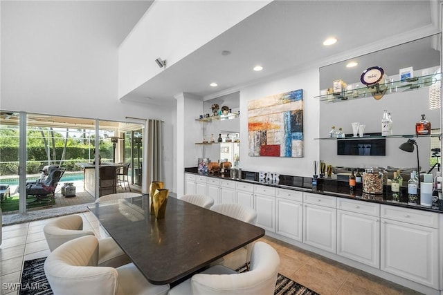 bar with ornamental molding, light tile patterned flooring, recessed lighting, and indoor bar