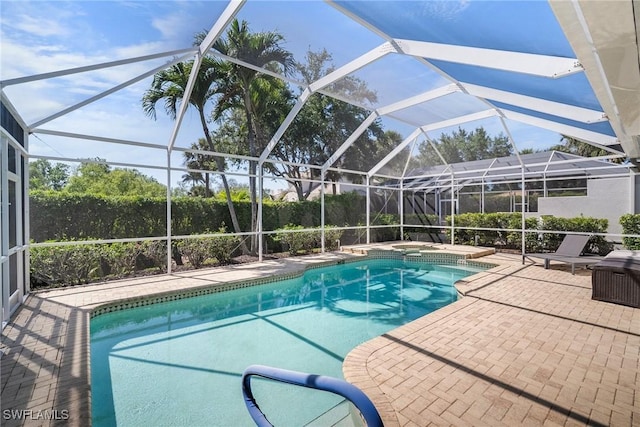 view of swimming pool featuring a fenced in pool, a patio, and a lanai