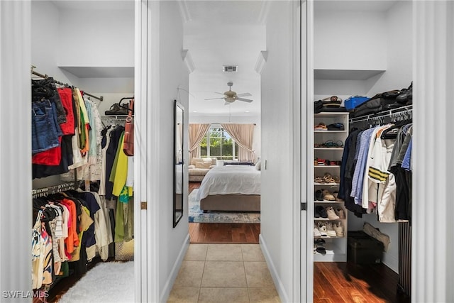 walk in closet featuring decorative columns, tile patterned flooring, visible vents, and a ceiling fan