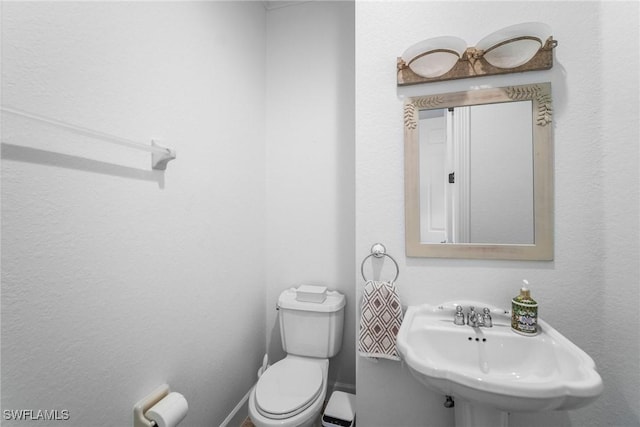 bathroom with toilet and a sink