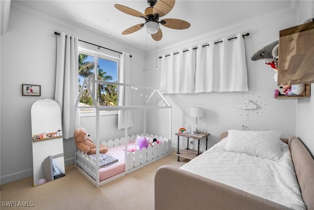 bedroom featuring carpet flooring, baseboards, crown molding, and ceiling fan