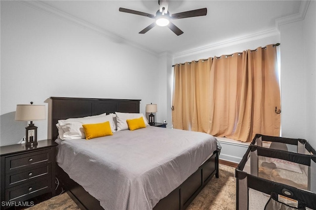 bedroom featuring crown molding, baseboards, a ceiling fan, and wood finished floors