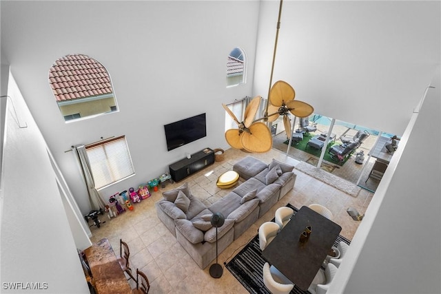 tiled living room featuring a high ceiling