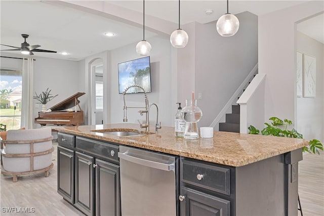 3544 Brittons Ct, Fort Myers, FL 33916 - kitchen with stainless steel dishwasher, light wood finished floors, a sink, and a ceiling fan