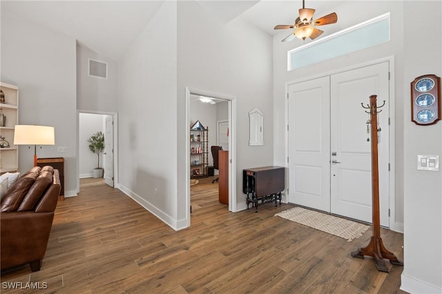 14190 Binghampton Dr, Fort Myers, FL 33905 - foyer entrance with a ceiling fan, high vaulted ceiling, wood finished floors, and healthy amount of natural light
