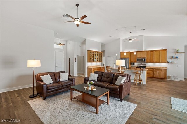14190 Binghampton Dr, Fort Myers, FL 33905 - living area with a ceiling fan, high vaulted ceiling, and light wood finished floors